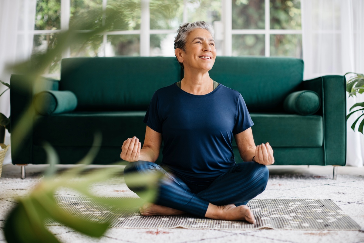 Woman doing yoga in living room