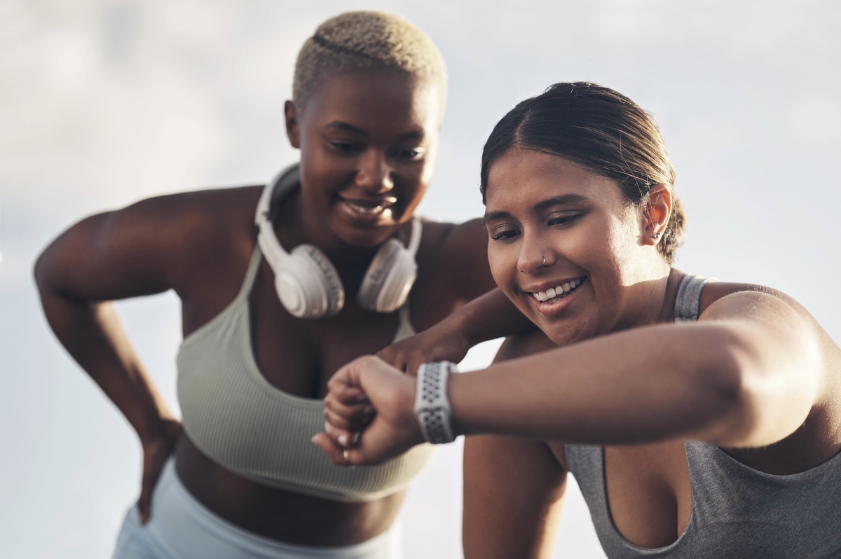 Women tracking workout progress on watch